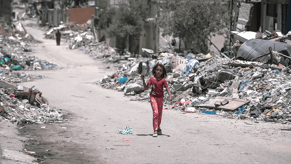 A girl walks inside Gaza during the Gaza-Israel war to get food